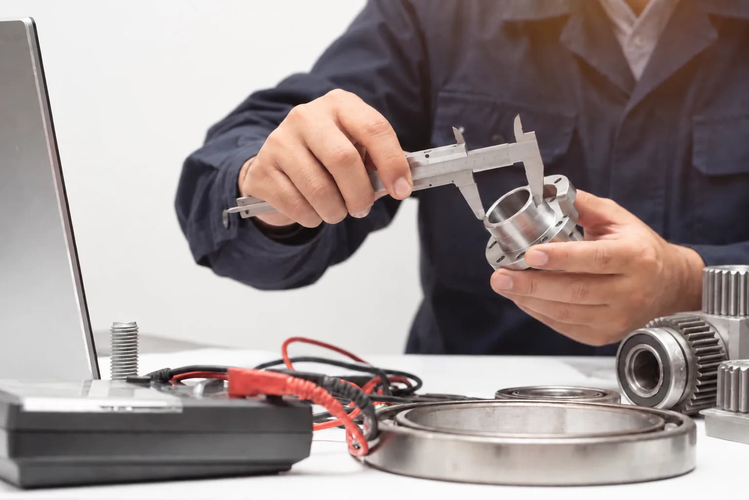 Checking a component with a caliper on the test bench